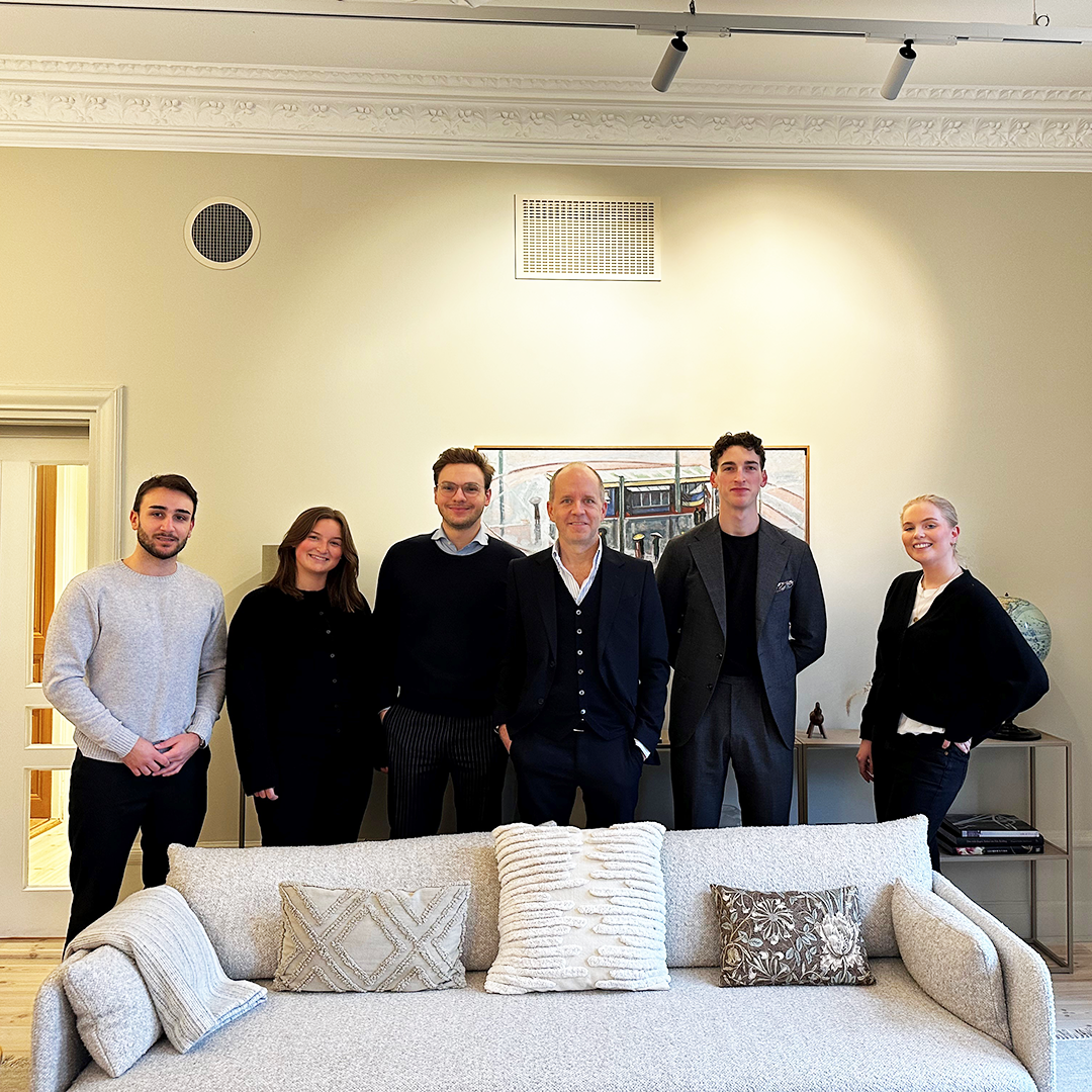 People standing in row and smiling in front of camera at the Axel Johnson head office