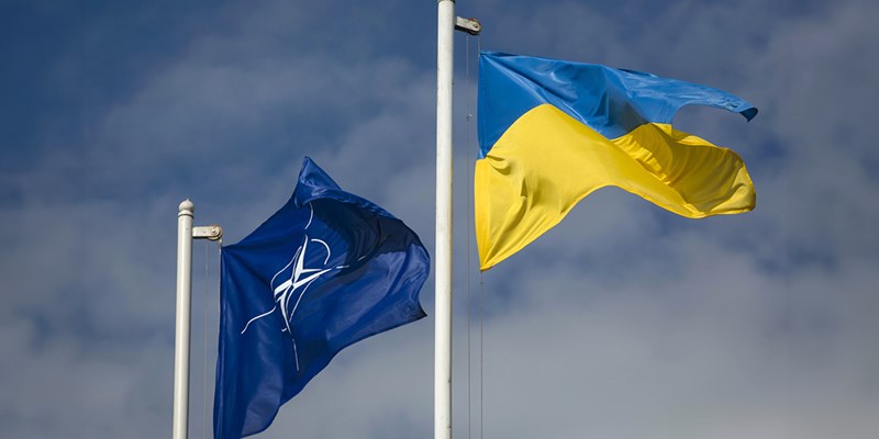 The national flag of Ukraine and NATO flag