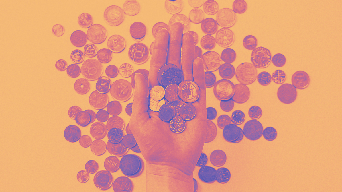 A hand full of coins.