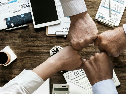 Hands together over a table