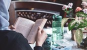 Women in hijab reading book