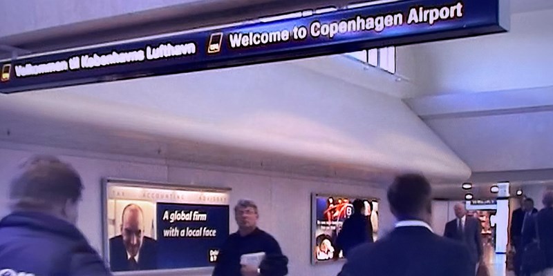 Still from MEN AT KASTRUP, showing a businessman walking through the airport