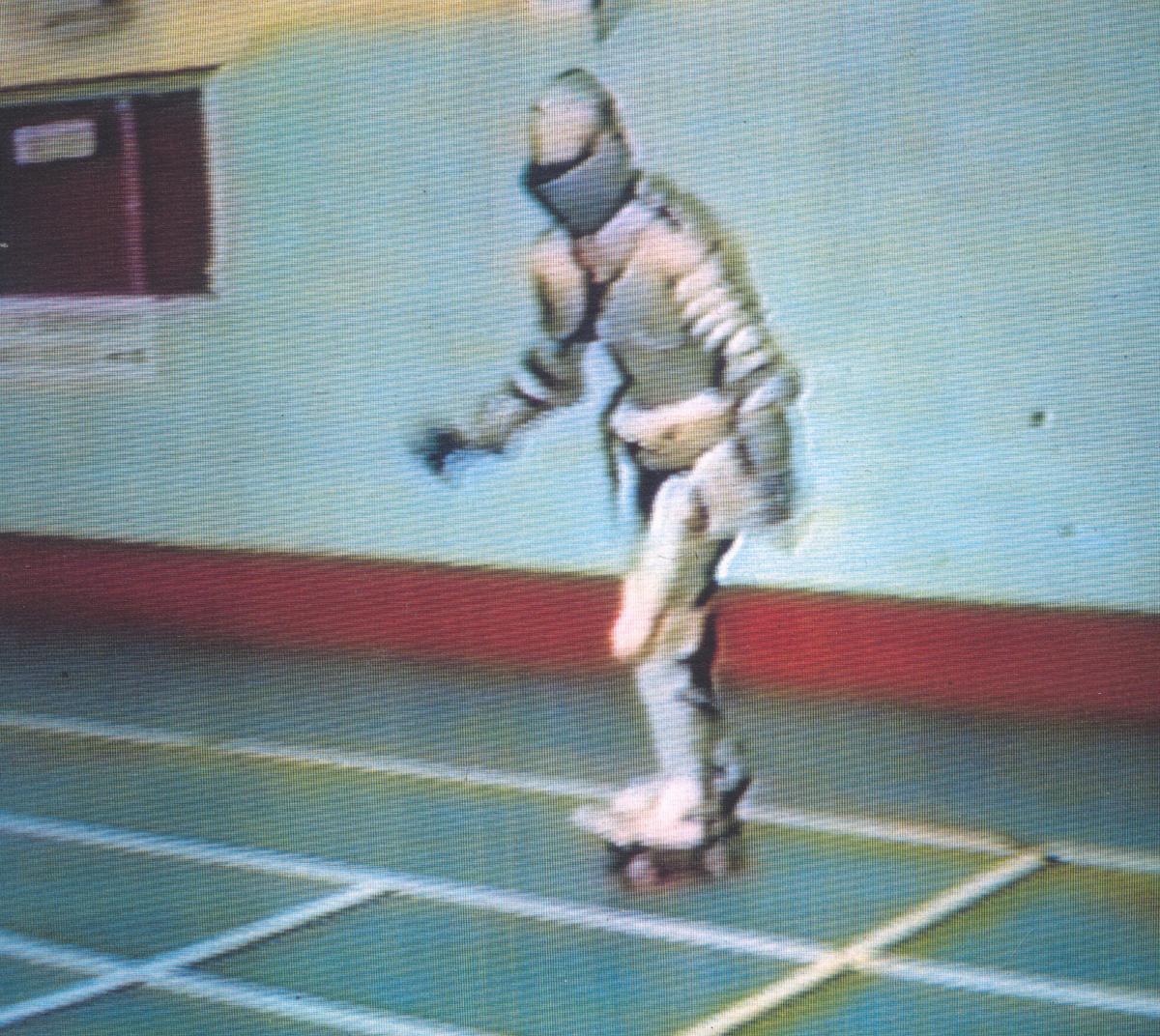 Still from Vangelis Vlahos's video Untitled Knight I, showing a figure in knight's armour in a gymnasium