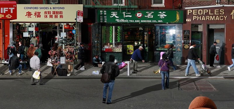 A New York street scene built from stop-frame stills, shopfront signage and passers-by held mid-step.