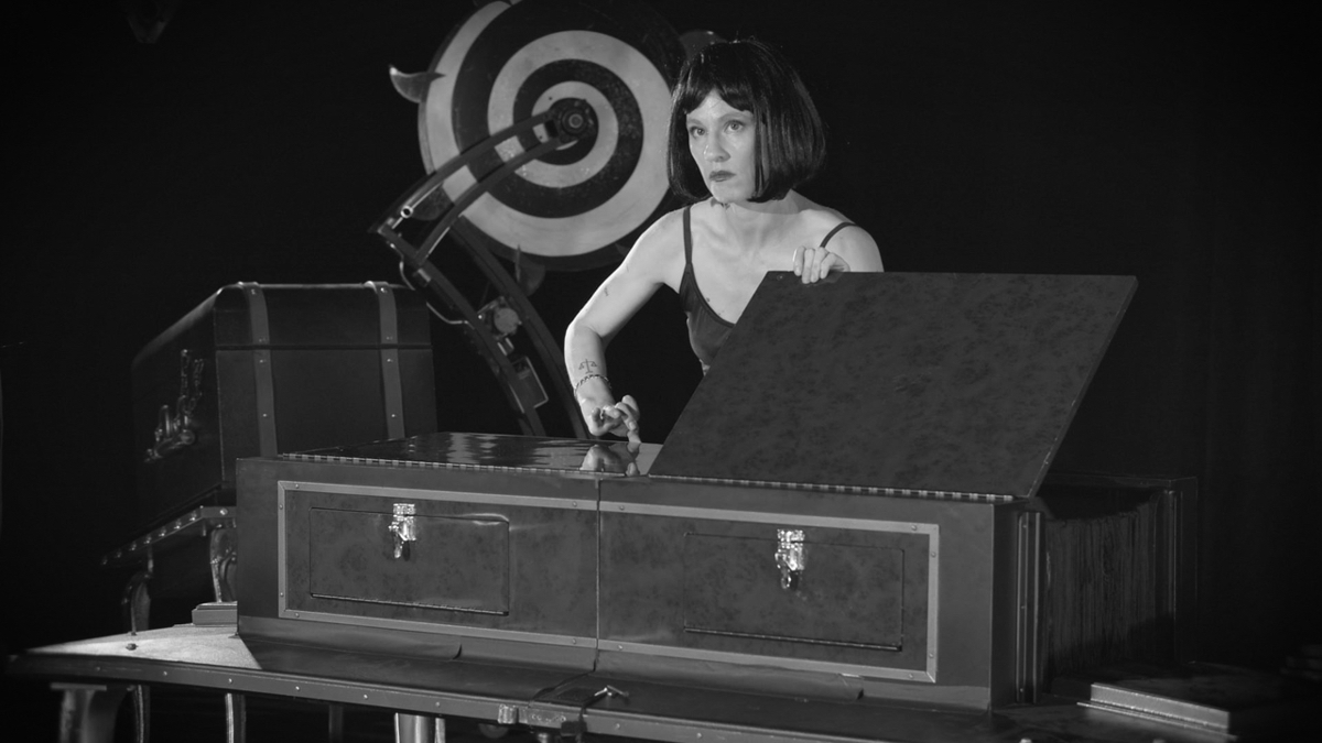 Still from Tova Mozard's film The Mismade Girl, showing a magician's stage performance 