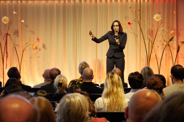Professor Julie Battilana stands on stage in the Aula at the Stockholm School of Economics to deliver her keynote at the HoSS Forum 2026.