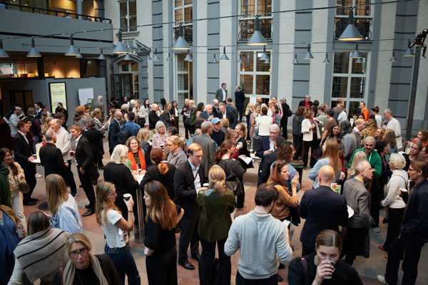 Wide shot of the fika break in a packed Atrium at the Stockholm School of Economics during the HoSS Forum 2026.