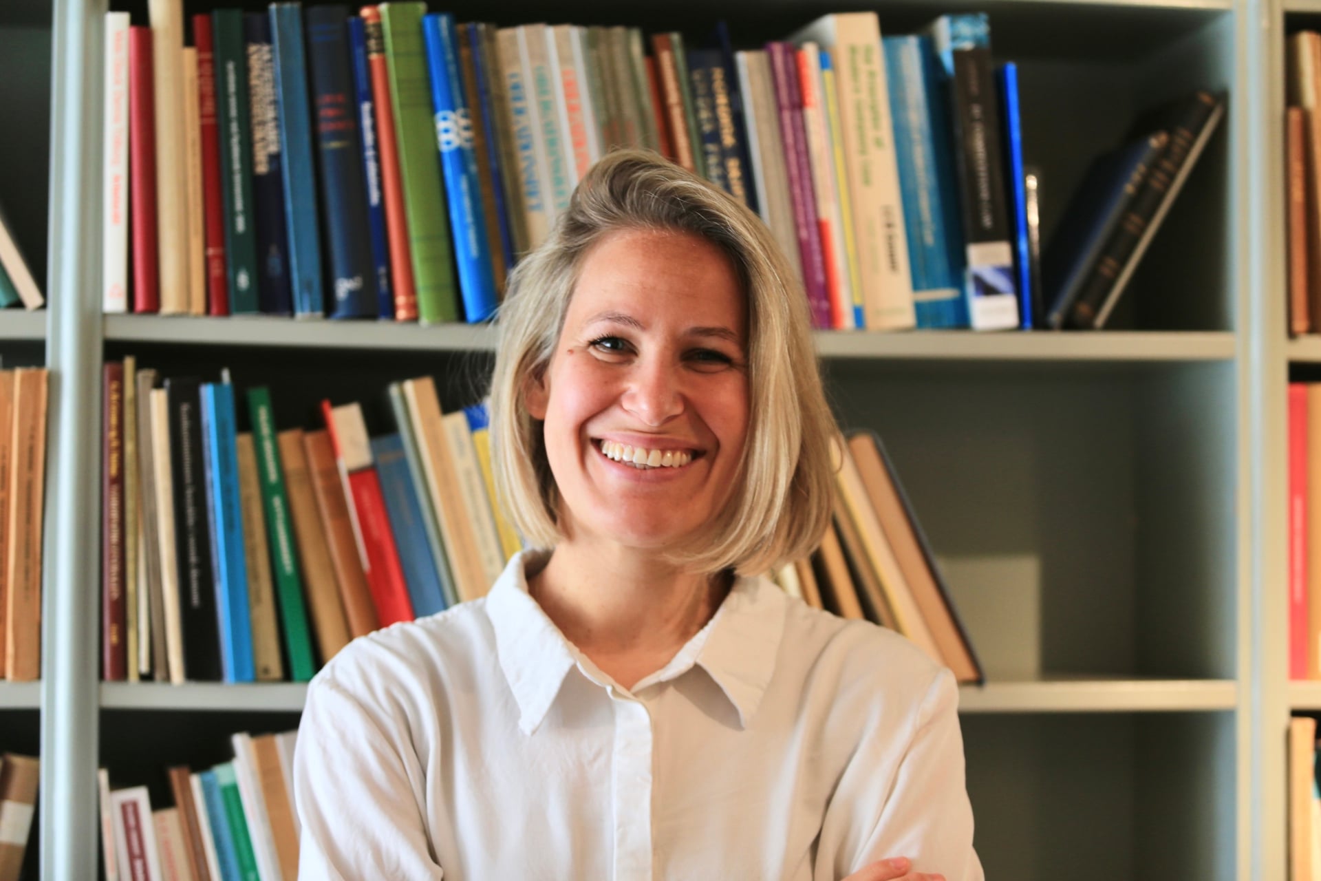 Portrait photograph of Julia Grimm in a library.