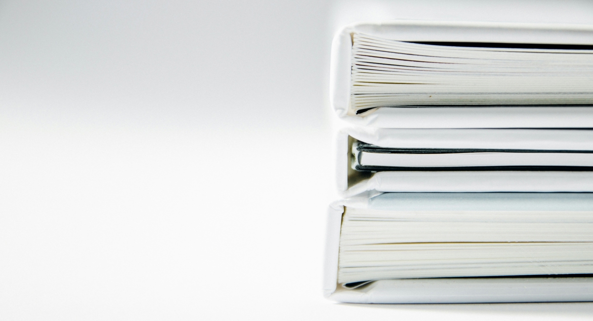 Annual reports lying on a white table.