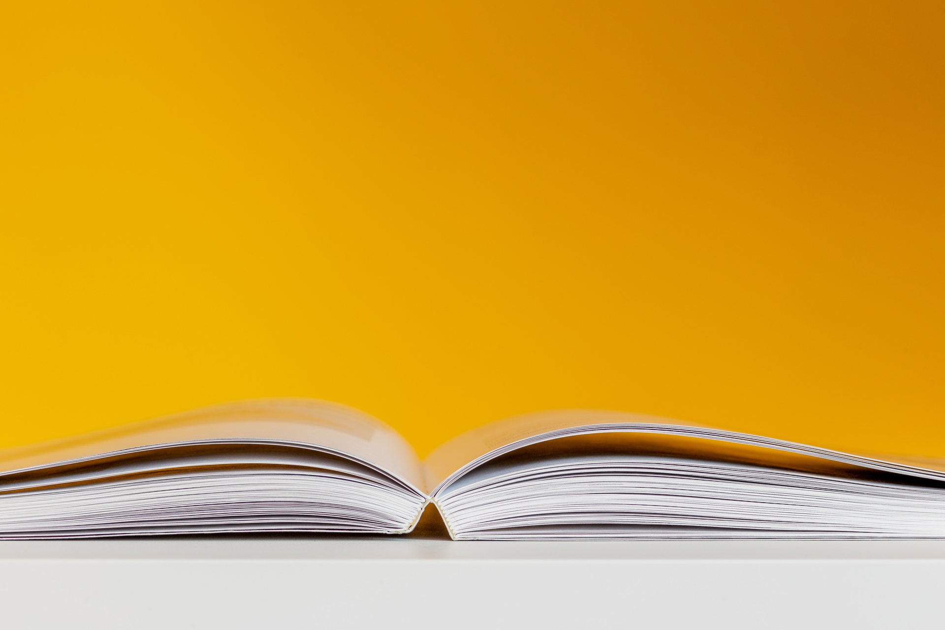 An open book with a yellow background.
