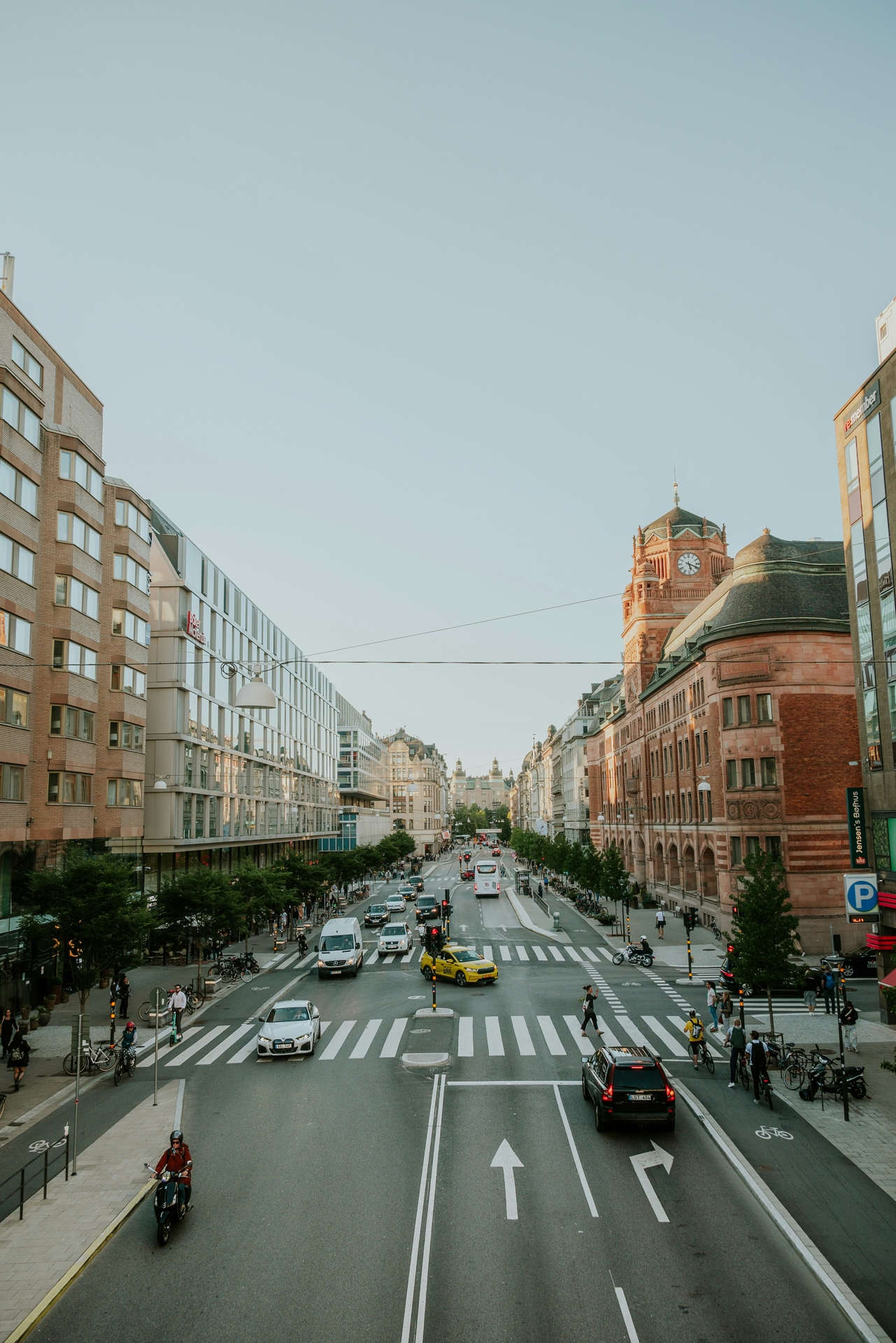 City street in Sweden with cars driving down it.